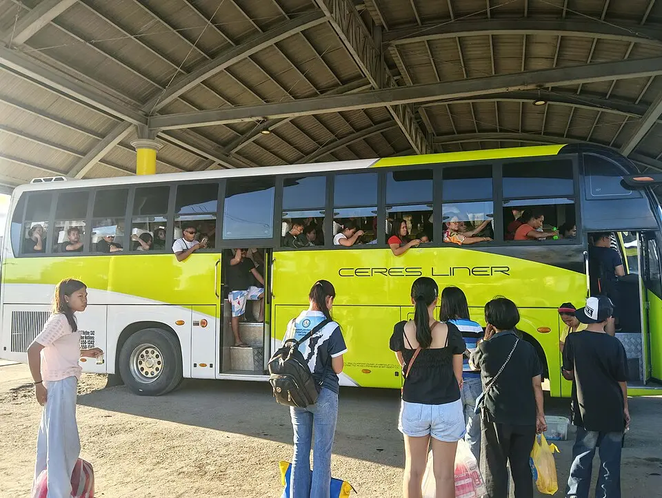 Passengers boarding a Ceres Liner bus at a Philippine bus terminal, Cebu